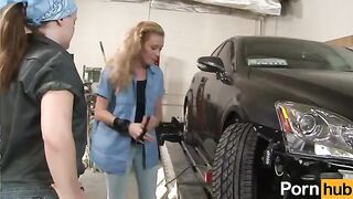 A teenage girl is being trained by a lesbian mentor in the garage