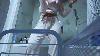 The girl caresses her pussy in the bathroom, feeling excited and wet