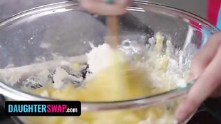 Two stepdaughters are backing a pie for their dads in the kitchen