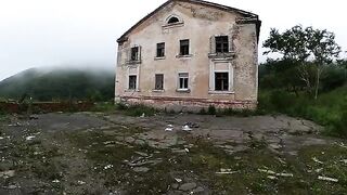 An exhibitionist girl walks through abandoned buildings, getting intimate in risky spots