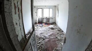 An exhibitionist girl walks through abandoned buildings, getting intimate in risky spots
