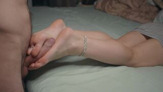 The petite girl shows her small feet and performs a foot job, ending with a hot finish on her soles