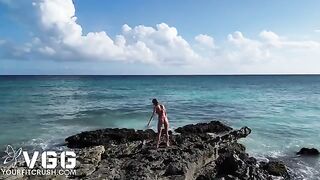 A hot girl is masturbating on a nude beach, showcasing her solo play