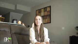 A step mom shares a couch with her stepson in a taboo roleplay