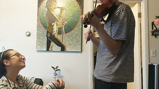 A couple gets passionate while the girl tries to practice violin, showcasing real intimacy