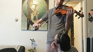 A couple gets passionate while the girl tries to practice violin, showcasing real intimacy
