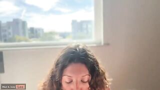 A cute wife demonstrates her oral and riding skills in public, right by the window