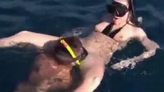Two aqua analysts are having fun at the bottom of the sea