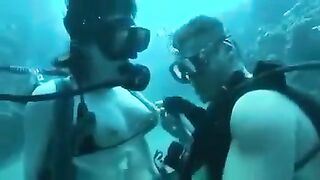 Two aqua analysts are having fun at the bottom of the sea