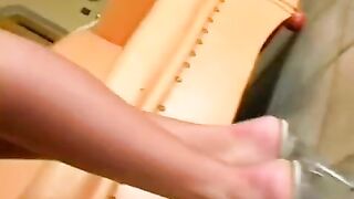 The pretty woman masturbates in a leather chair and achieves orgasm