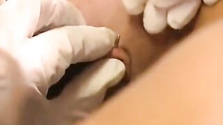 A girl plays with her new clitoris piercing