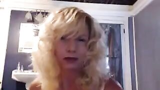 A mature woman has fun in the bathroom with a toy