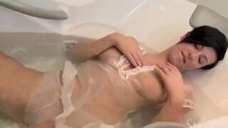 Brunette woman with long hair has sex with herself in the shower