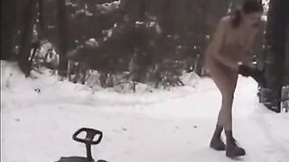 Two cute naked girls play snowball fights on the city streets