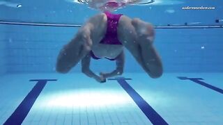 A hot and sexy chick is swimming naked in the pool