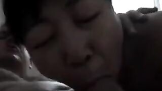 A Chinese woman practices her blowjob skills on him in a steamy scene
