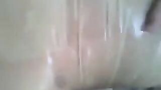 A guy put a condom on his cock and masturbated it