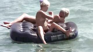 A naked girl is having fun on the mattress with someone