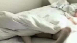 A girl masturbates in bed, unaware of the hidden camera