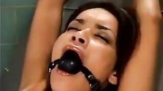 A bald guy fucks a girl with a machine for sex using bondage