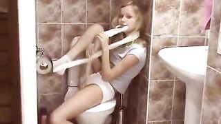 A blonde is doing her business in the public toilet and surprises someone