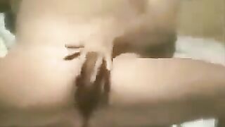 A girl masturbates on the beach, unaware of the camera capturing her