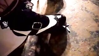 A cute girl plays with her pussy on the toilet bowl