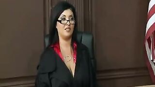 A woman in a power suit with very big boobs