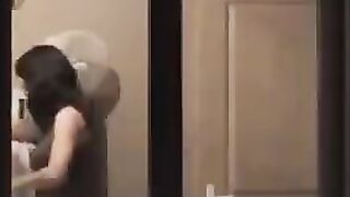 A hot brunette poses naked in front of the mirror, admiring herself with a big dick