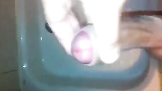 The kid masturbates his dick in the shower stream