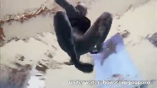 A sexy girl is floating in the pool without clothes