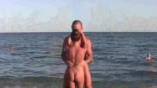 A group of naked acrobats are performing on the nude beach