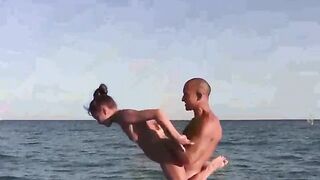 A group of naked acrobats are performing on the nude beach