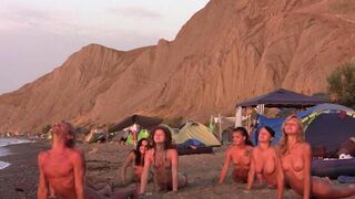 A group of girls are having fun playing volleyball naked on the nude beach