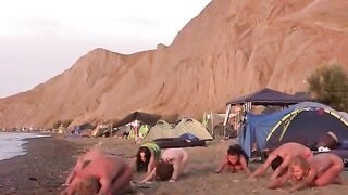A group of girls are having fun playing volleyball naked on the nude beach