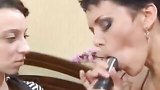 A mother is giving a lesson to her daughter on how to do a blowjob