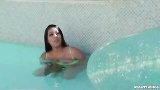 A girl has a swimming lesson with her coach in the pool