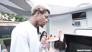 A black guy has sex with a girl at the BBQ in the spring
