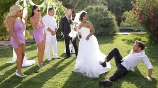 The bride is having fun with the best man and other guys in the hotel room