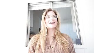 A blonde girl under the table gets a huge load of cum on her face