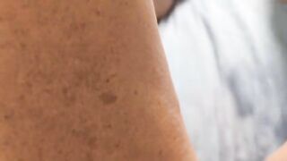 A woman caresses herself and reaches a squirting orgasm